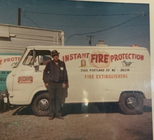Mark Fogal standing in front of the Instant Fire Protection van in the 1960's